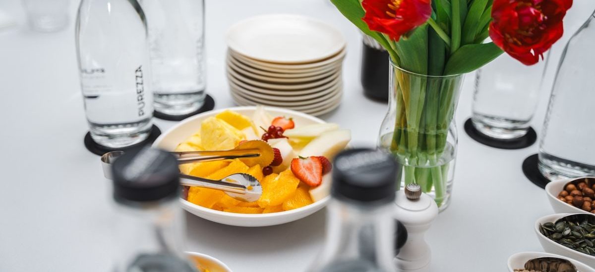 An elegant dining setup featuring fresh fruits and vibrant tulips, perfect for a healthy meal.