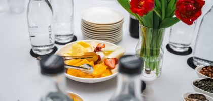 An elegant dining setup featuring fresh fruits and vibrant tulips, perfect for a healthy meal.