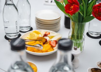 An elegant dining setup featuring fresh fruits and vibrant tulips, perfect for a healthy meal.